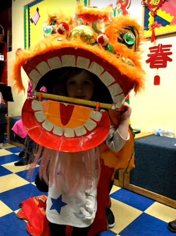 Youth Mandarin Class Student Wearing Traditional Lion Dance Head in School